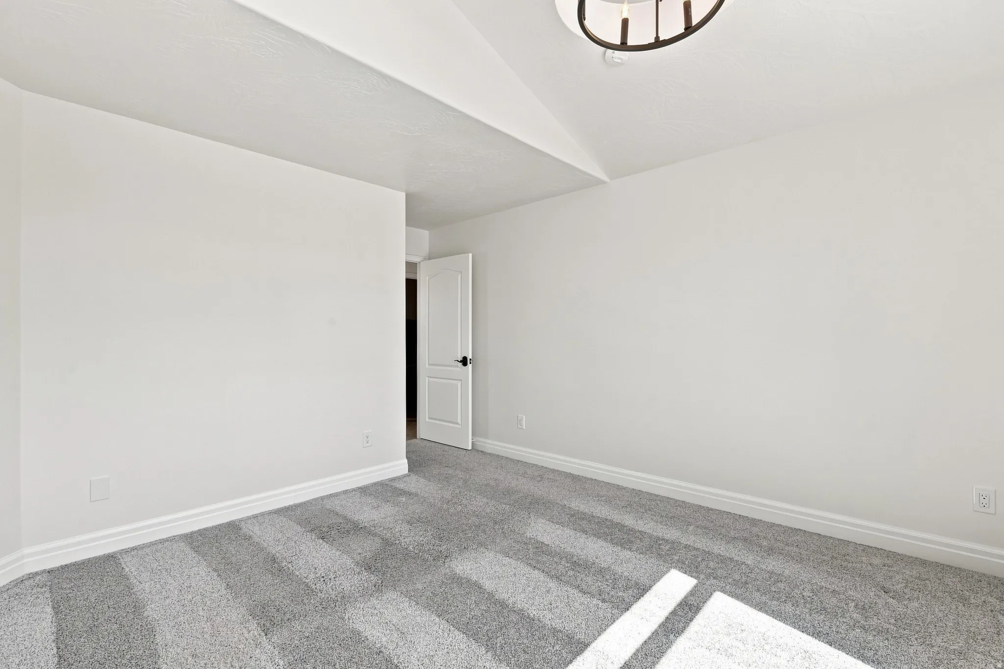 White painted walls complemented by gray patterned carpeting