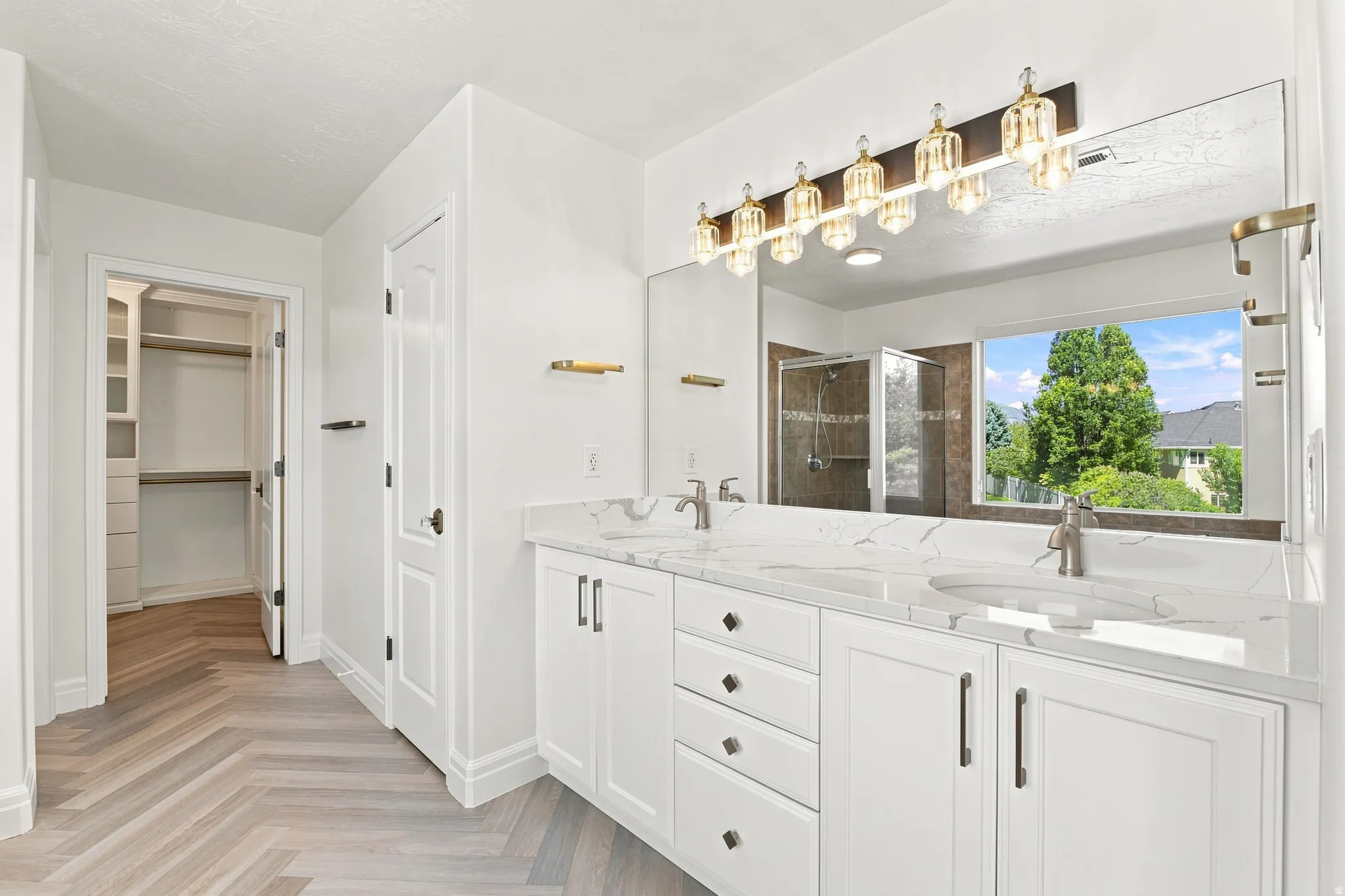 Dual vanity with white cabinetry and integrated sinks