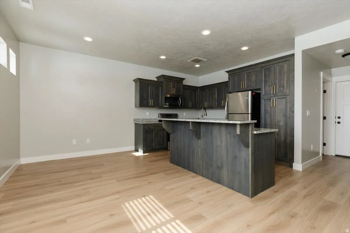 Open-concept living space with wood-finish flooring