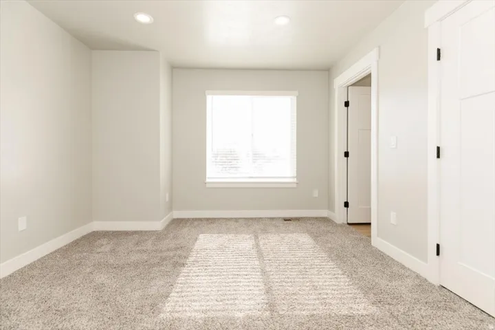 Plush carpeting throughout, neutral wall tones, recessed lighting, and white trim work