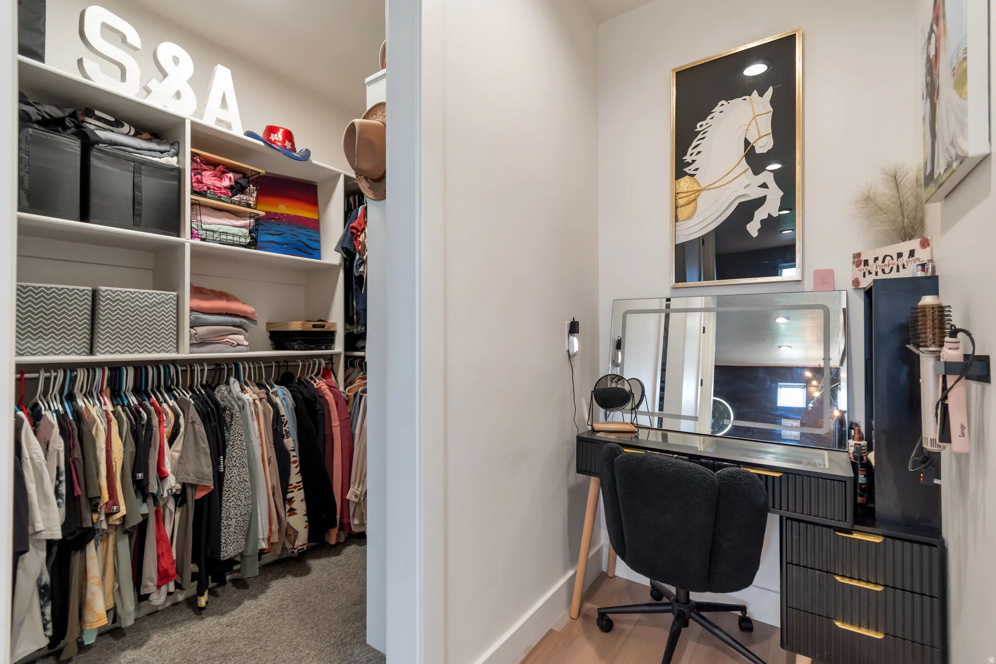 Custom closet system with white shelving and hanging rods