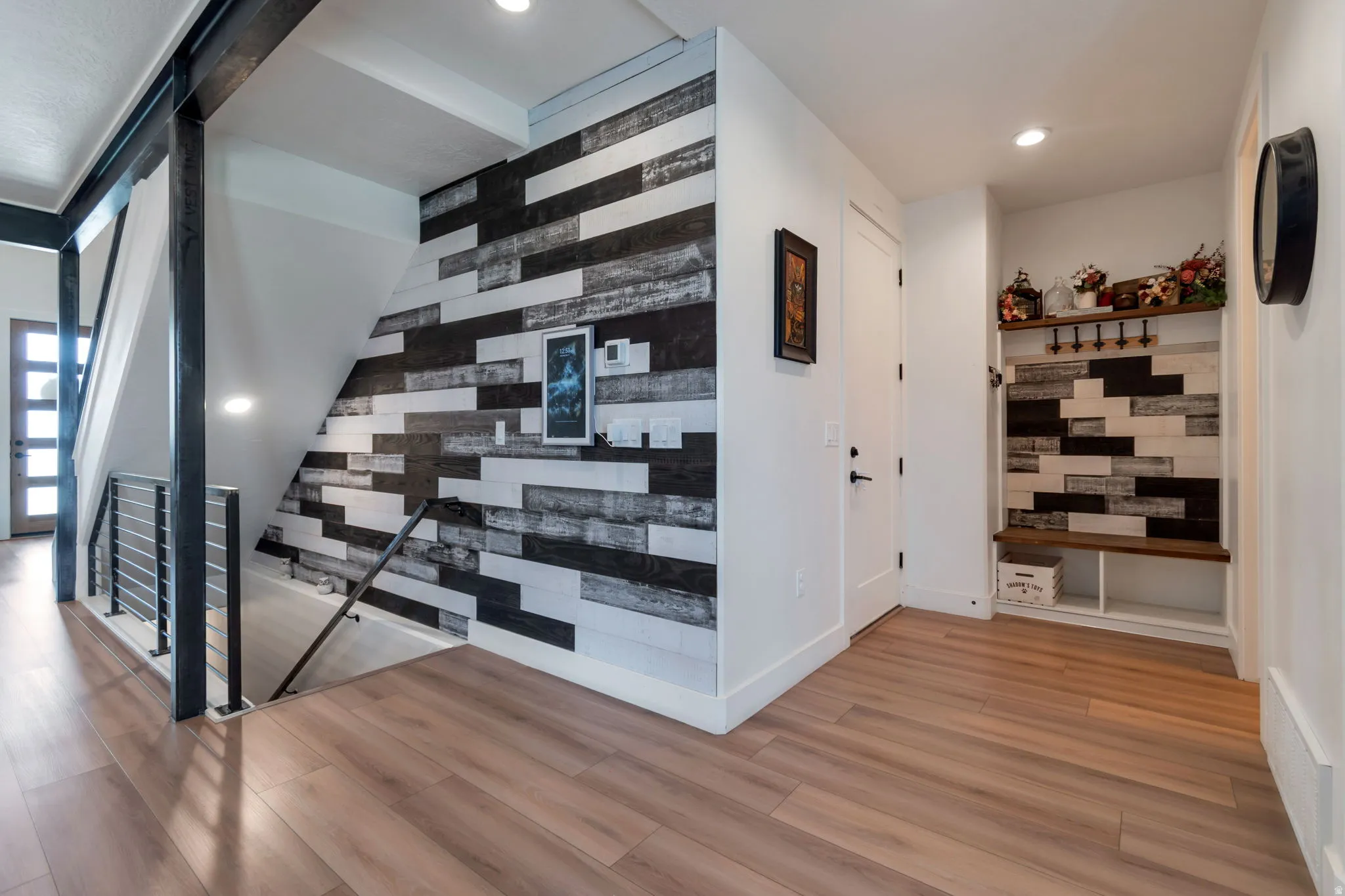 Wood-finish flooring throughout, with a built-in bench and shelving unit