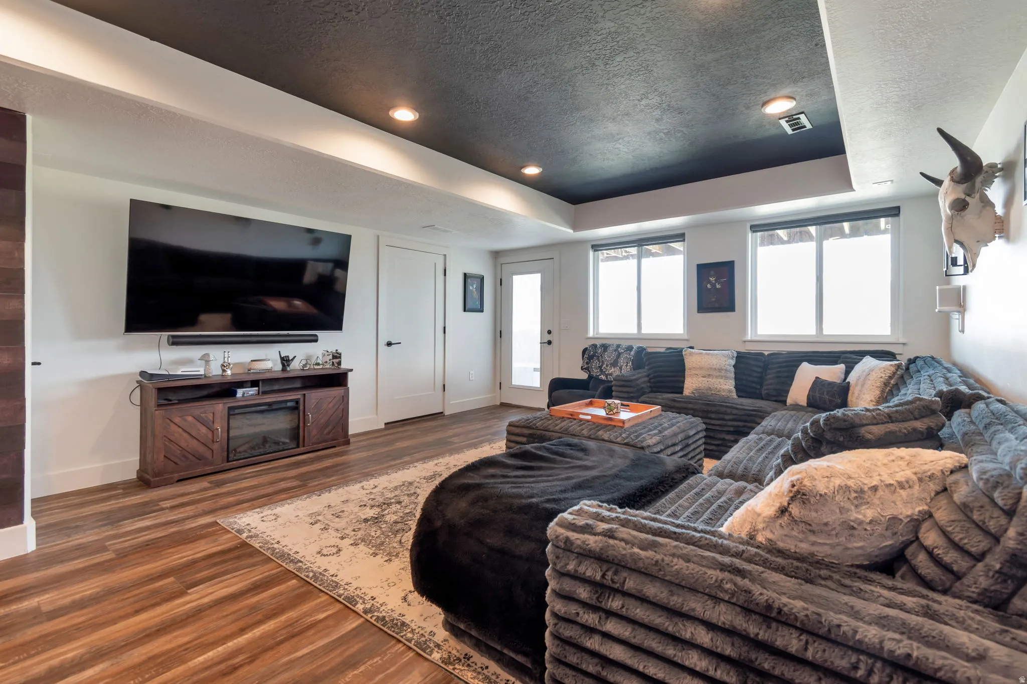 Recessed lighting, wood-finish flooring, and white interior doors