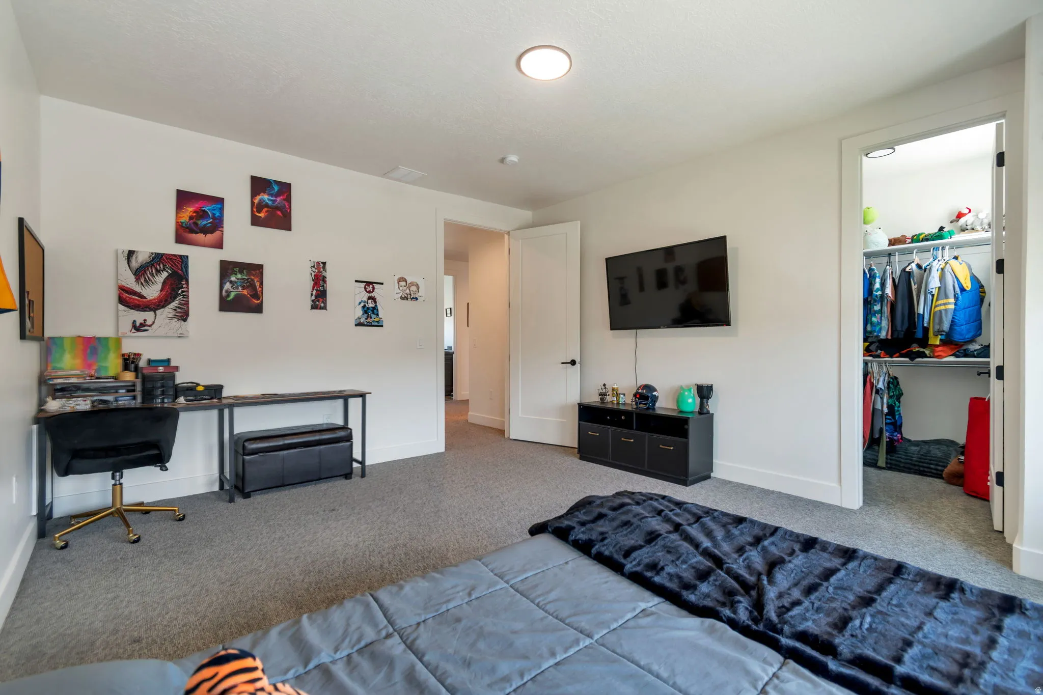 Carpeted room featuring a built-in closet with shelving and hanging rods