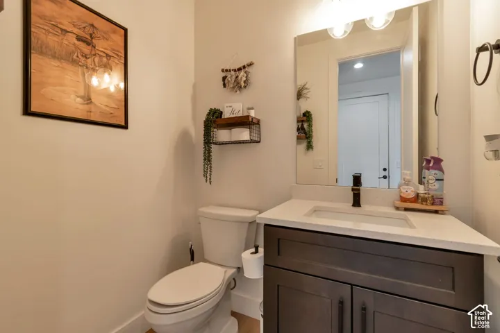 Vanity with a light-toned countertop, rectangular undermount sink, and dark bronze faucet
