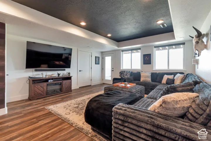 Recessed lighting, wood-finish flooring, and white interior doors