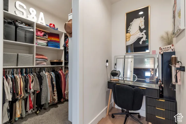 Custom closet system with white shelving and hanging rods