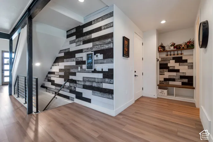 Wood-finish flooring throughout, with a built-in bench and shelving unit