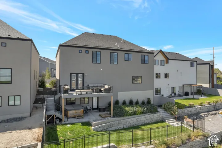 Multi-level exterior with a deck, patio, and terraced landscaping