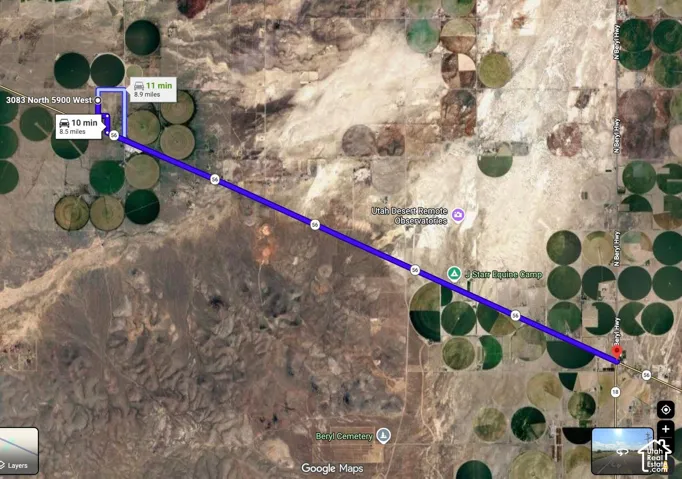 Satellite Map. Illustrating a route with distance and time indications, alongside identified landmarks and circular agricultural fields