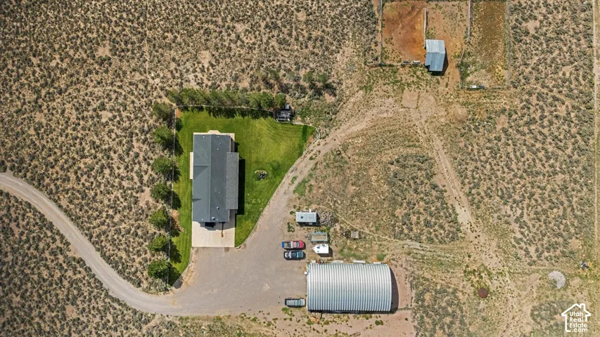 Expansive lot featuring a main residence, detached outbuilding, and additional structures
