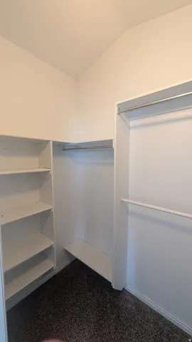 Built-in closet shelving, dual hanging rods, and corner storage