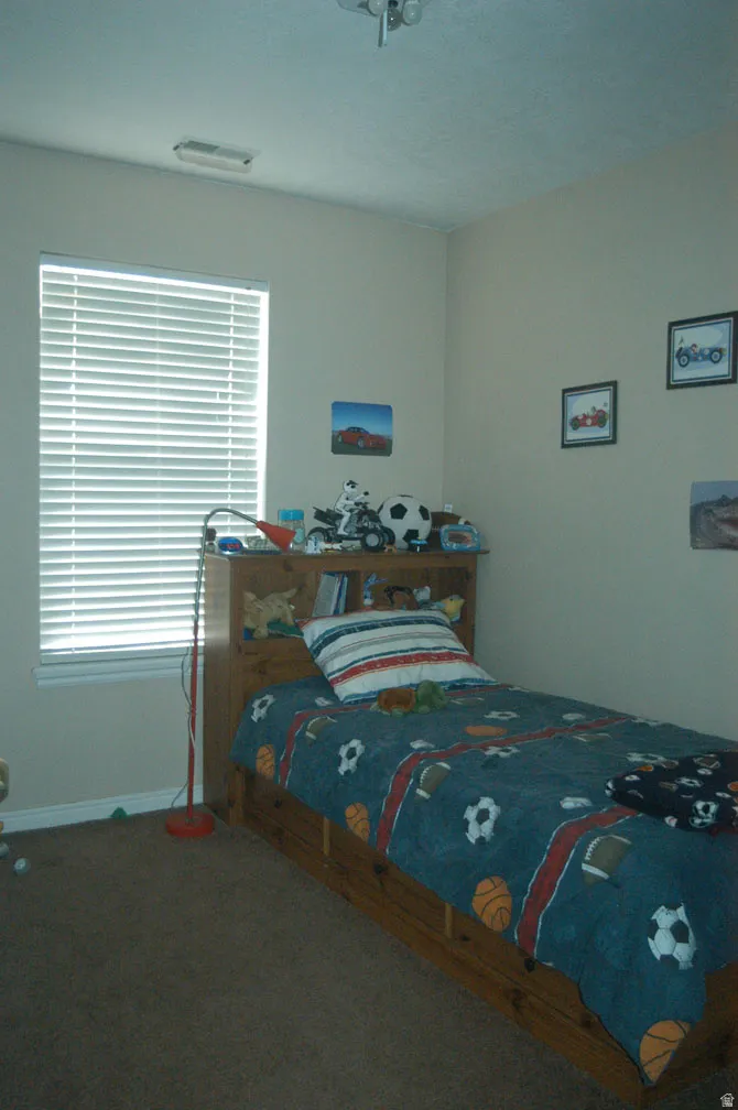 Recessed window with horizontal blinds, neutral wall paint, and ceiling-mounted light fixture