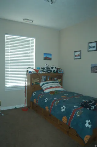 Recessed window with horizontal blinds, neutral wall paint, and ceiling-mounted light fixture