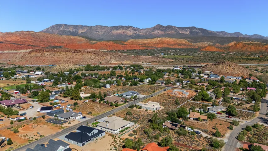 Expansive residential area featuring established homes, undeveloped lots, and arid landscaping