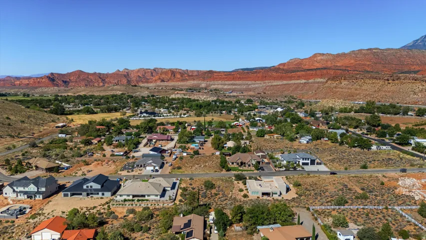 Expansive high desert landscape with red rock formations