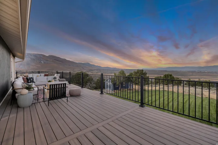 Expansive composite deck with black metal railings, offering a broad scenic landscape