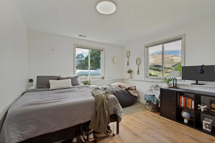 Wood-finish flooring, recessed lighting, and dual windows with mountain scenery