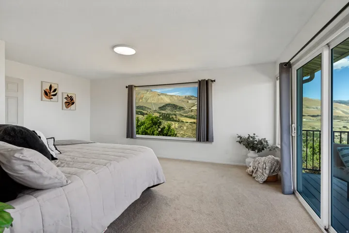 Carpeted flooring, white walls, flush mount lighting, sliding glass door, and a horizontal window
