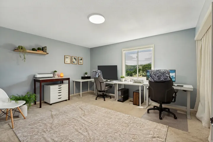 Recessed lighting, large window with outdoor scenery, light-colored walls, and carpeted flooring