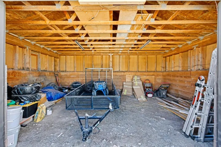 Open-frame ceiling with exposed wooden trusses and support beams