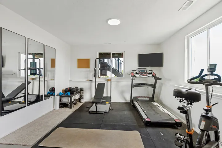 Recessed ceiling lighting, large windows, wall-mounted display, and durable flooring