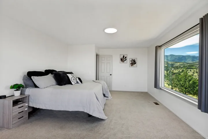 Large window featuring an expansive mountain and valley landscape