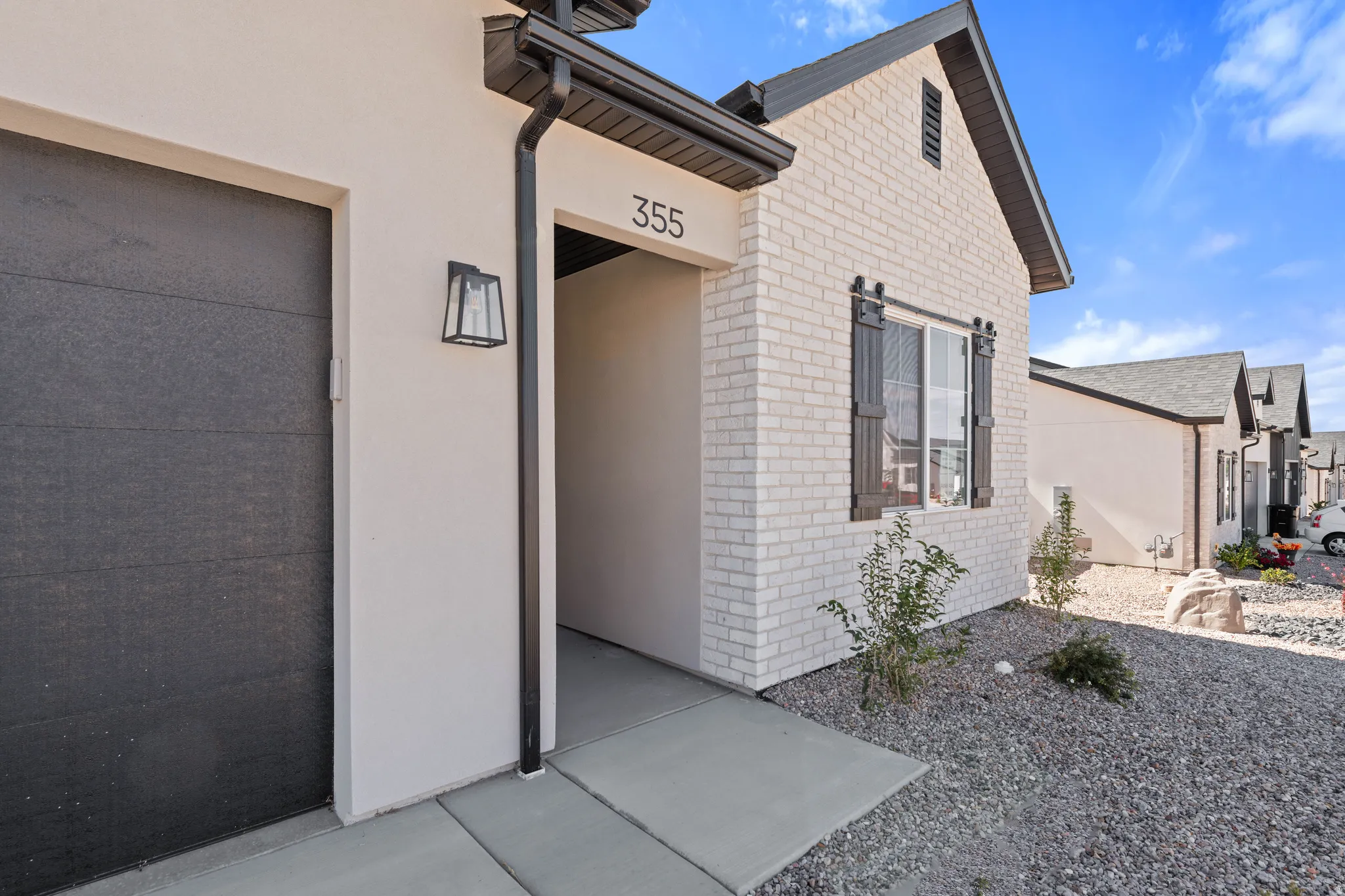 Contemporary exterior with light-colored brick and stucco finishes