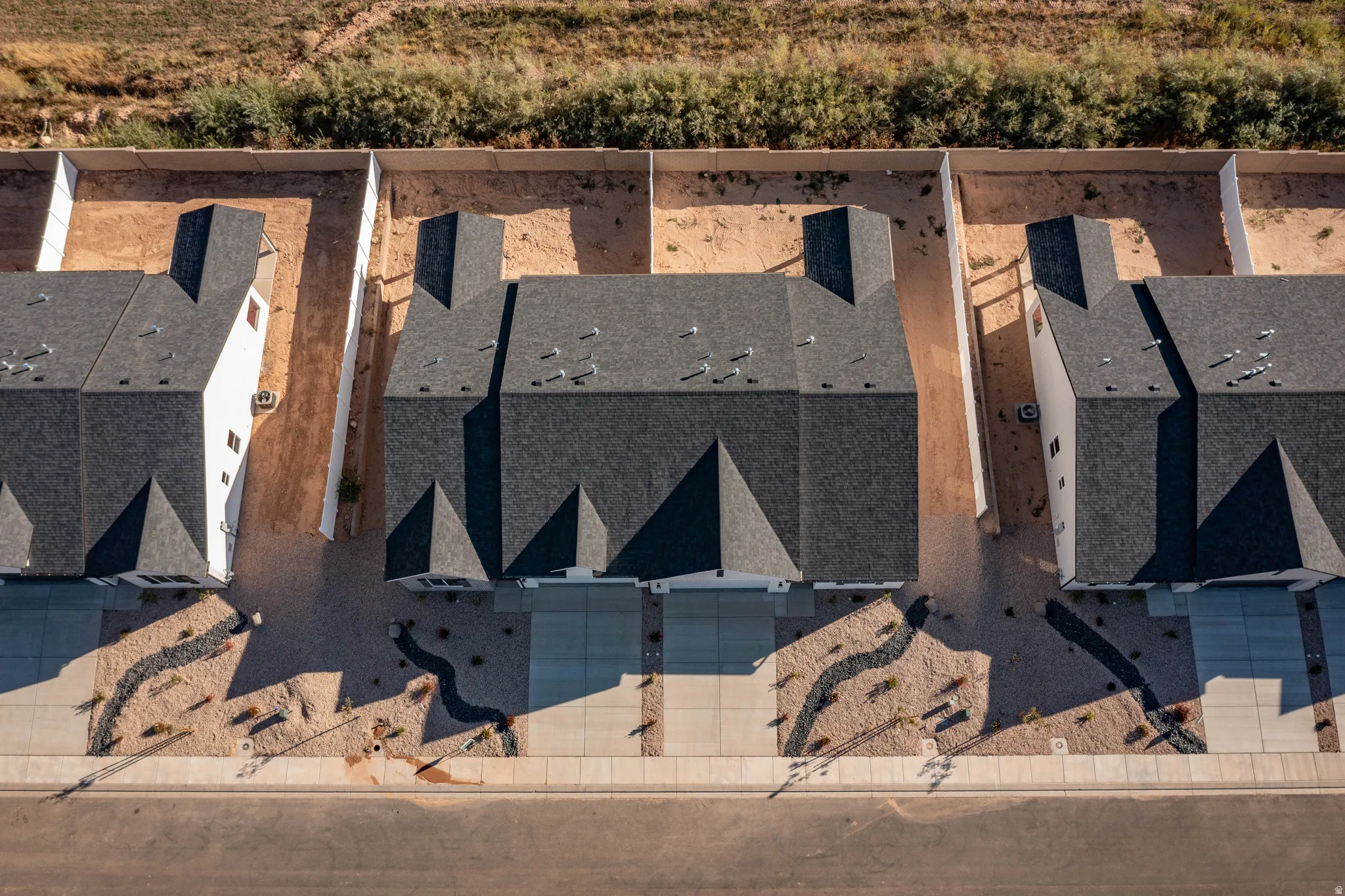 Contemporary rooftops featuring dark shingle material