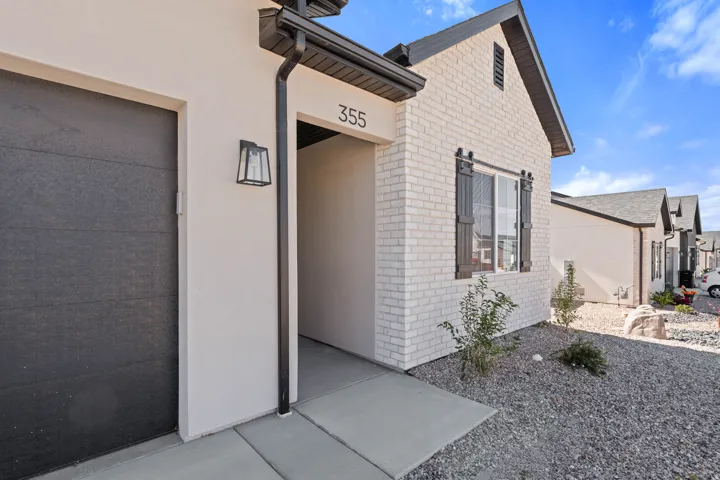 Contemporary exterior with light-colored brick and stucco finishes