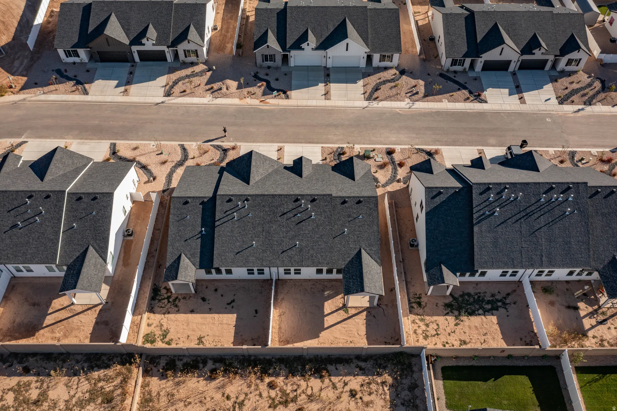 New construction residential development featuring asphalt shingle roofs and white exteriors