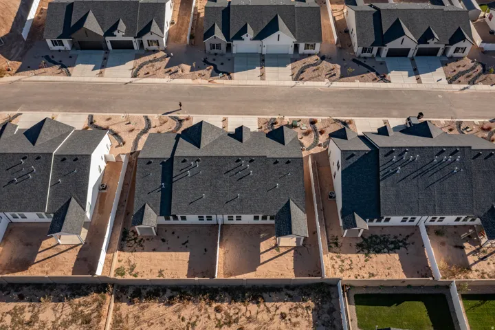 New construction residential development featuring asphalt shingle roofs and white exteriors