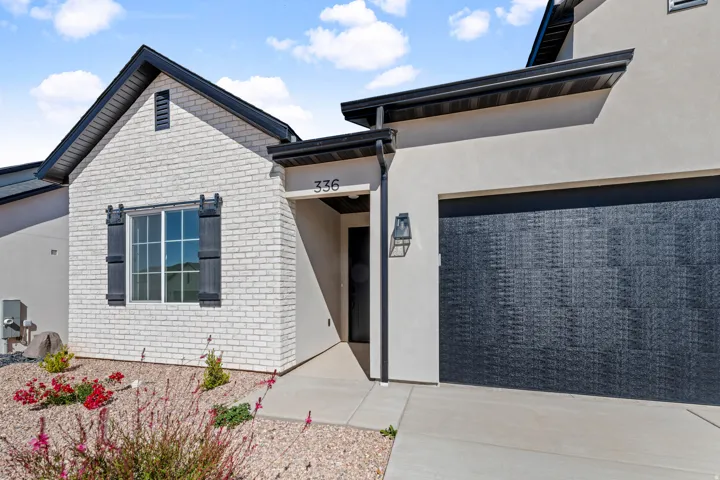 White brick facade with dark shutters
