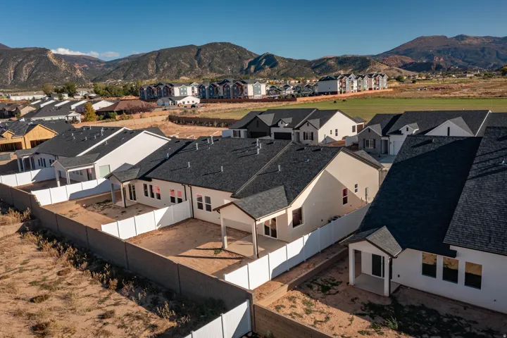 Newly constructed residences featuring contemporary exteriors, dark shingle roofs, and private fenced yards