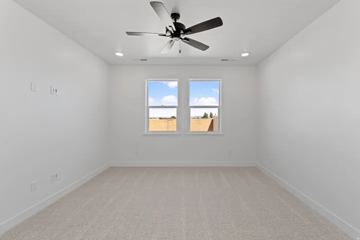 Recessed lighting, ceiling fan, and carpeted flooring