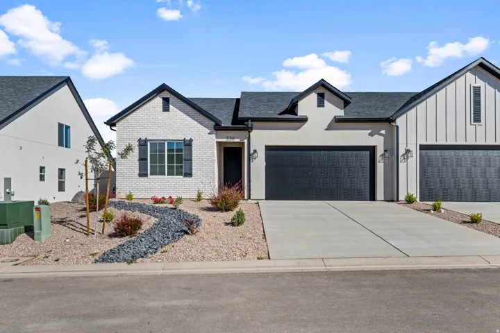 Modern stucco and brick exterior with contrasting dark trim