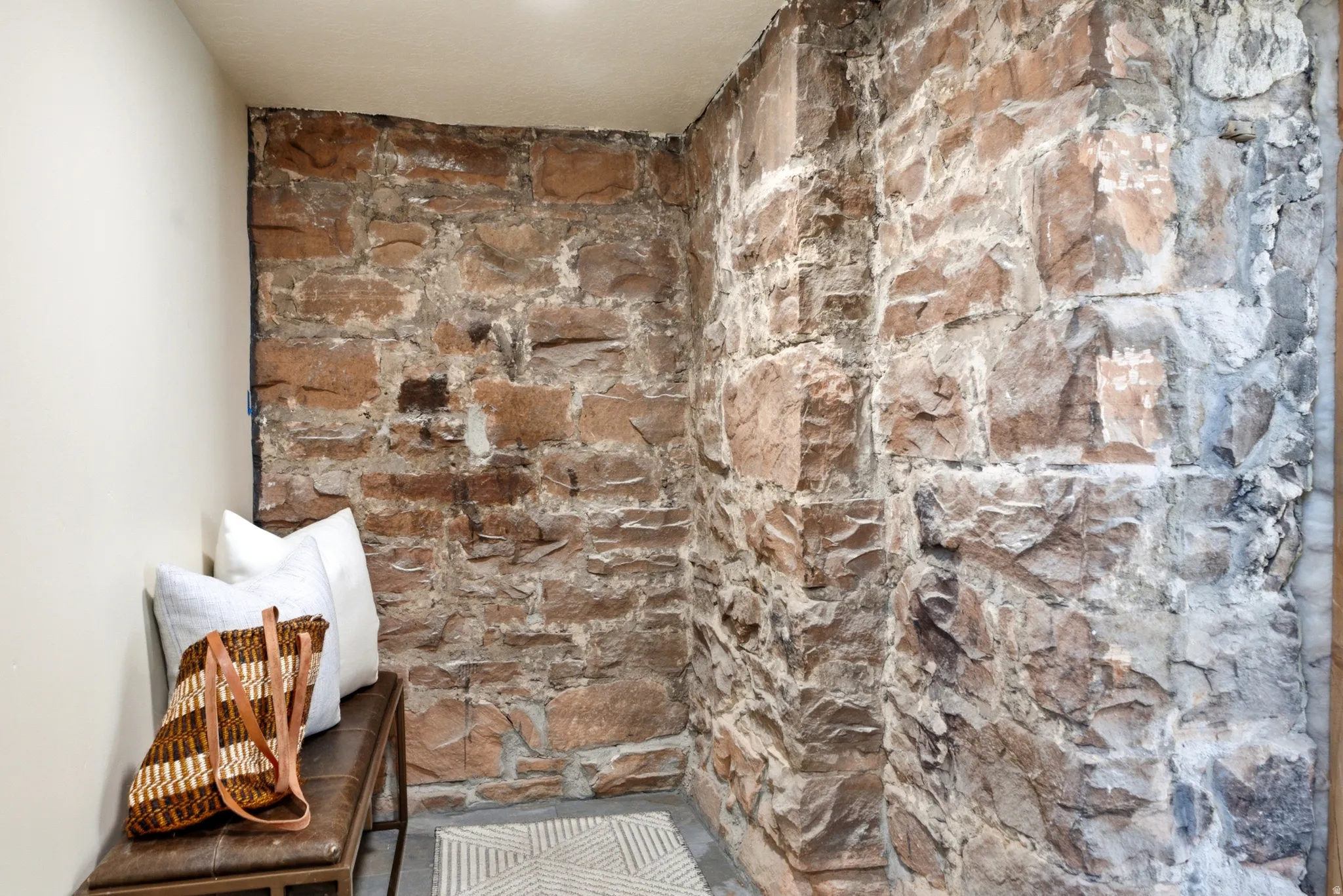 Exposed stone wall with varying earth tones