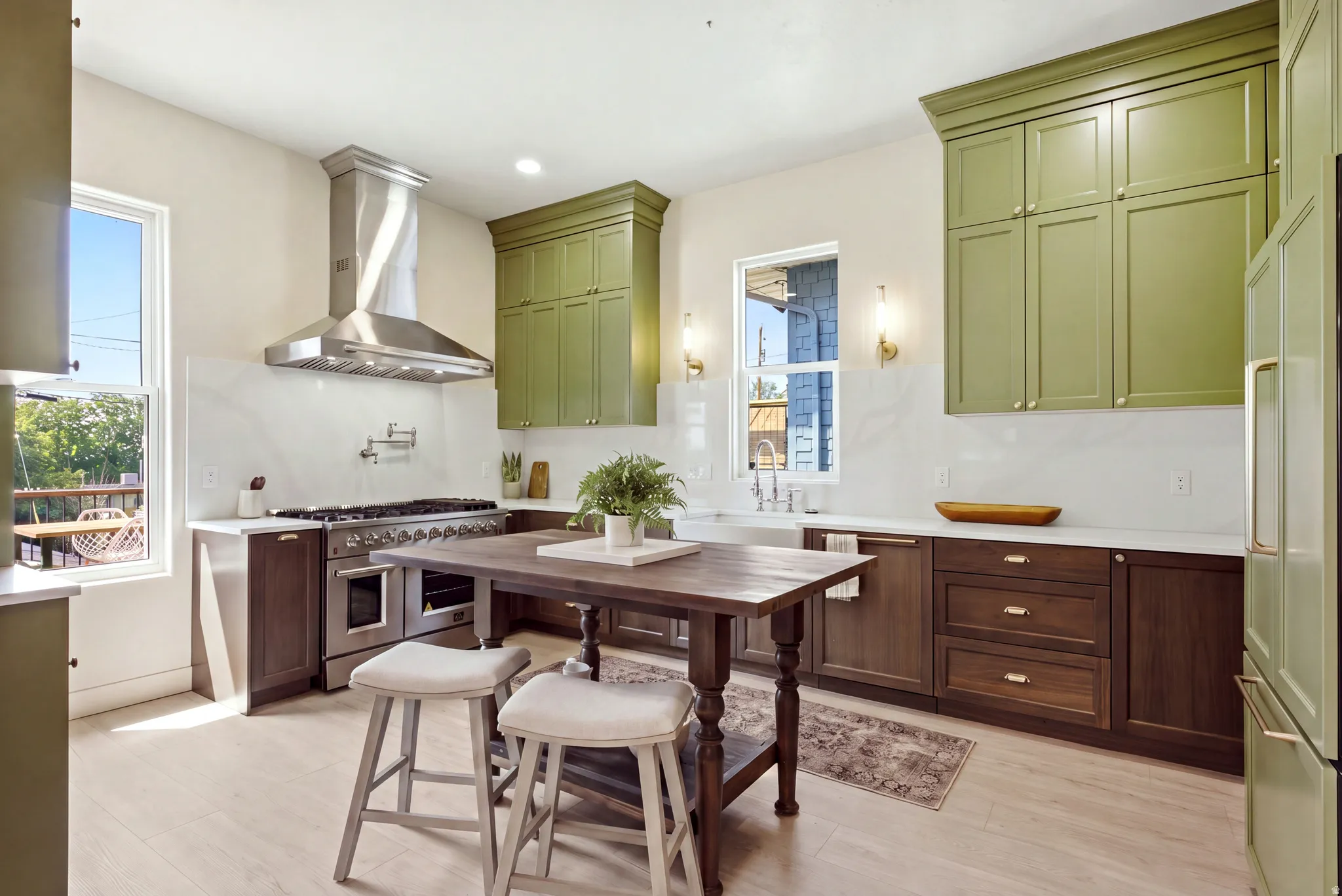 Gourmet kitchen with two-tone cabinetry, professional-grade range with a stainless steel hood, white countertops, and a full-height backsplash