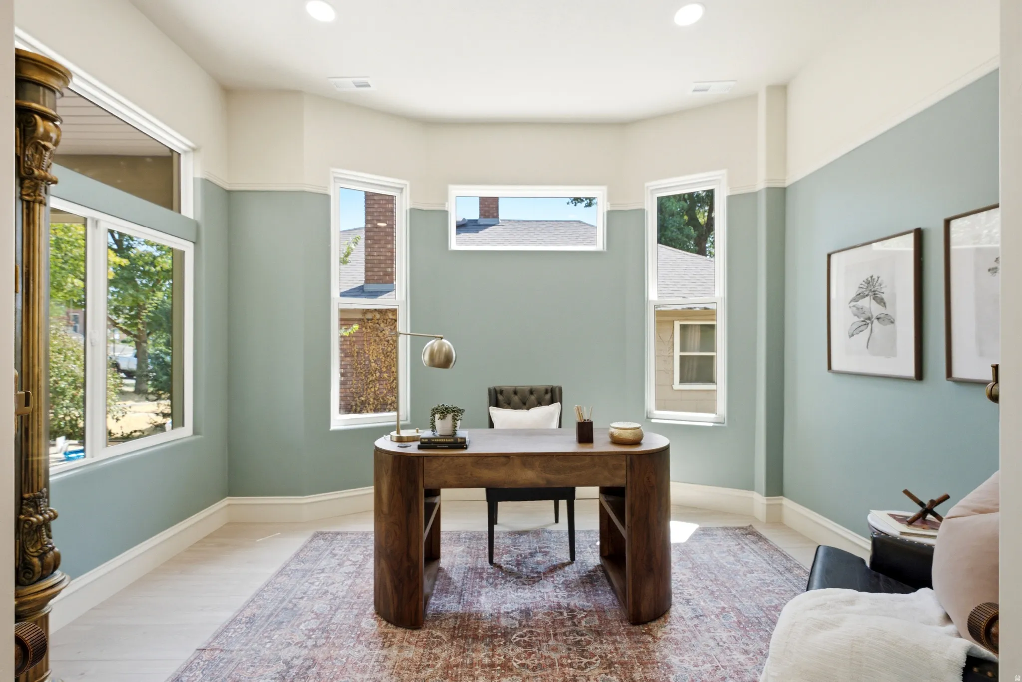 Recessed lighting, light wood-finish flooring, two-tone wall paint, multiple windows