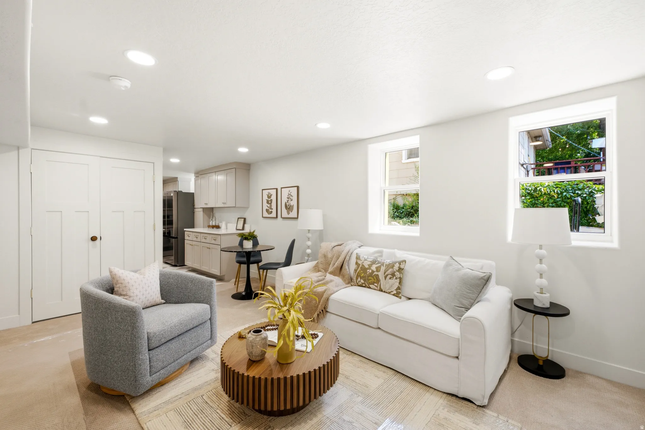 Recessed lighting, light-toned walls, wood-finish flooring, and white trim