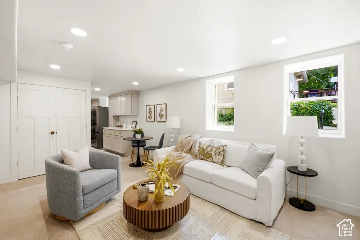 Recessed lighting, light-toned walls, wood-finish flooring, and white trim