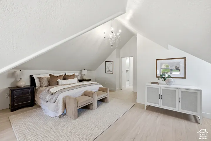 Vaulted ceilings, wood-finish flooring, and a crystal chandelier