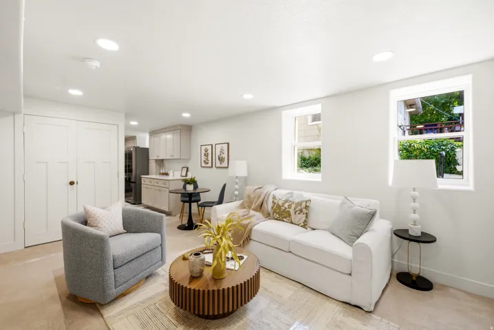 Recessed lighting, light-toned walls, wood-finish flooring, and white trim