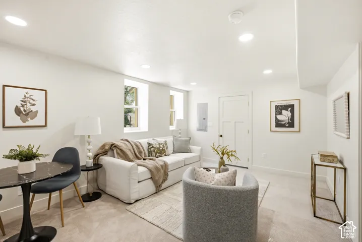 Recessed lighting illuminates the white walls and neutral carpet