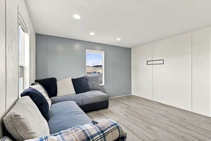 Recessed lighting illuminating wood-finish flooring