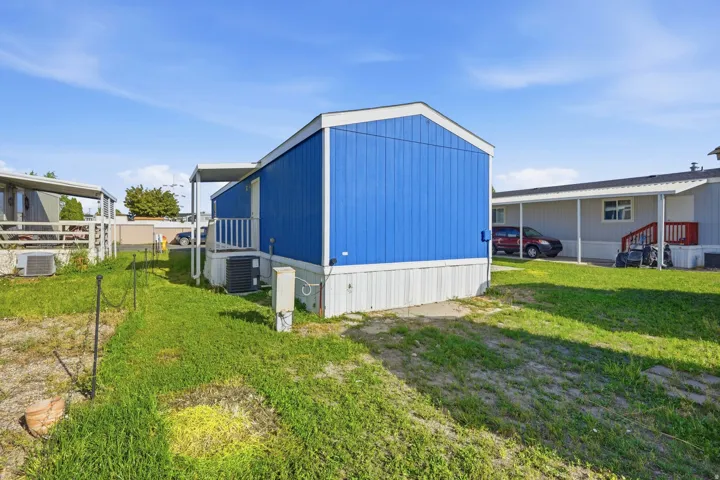 Blue vertical siding exterior with white trim and a covered entrance