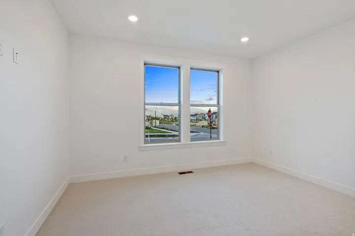 Recessed lighting and two windows with white trim