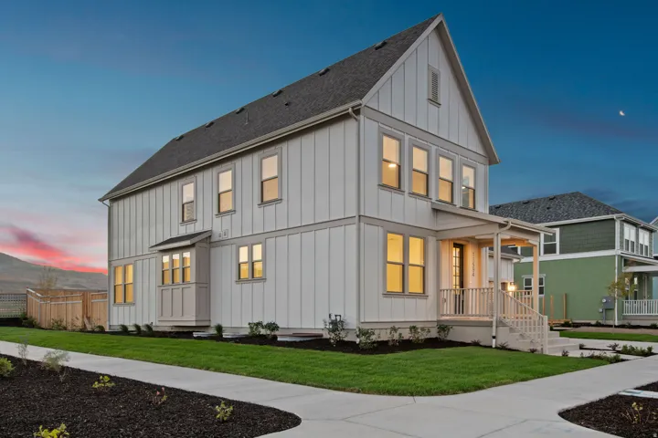 Board and batten exterior with a covered front porch, multiple windows, and a bay window feature
