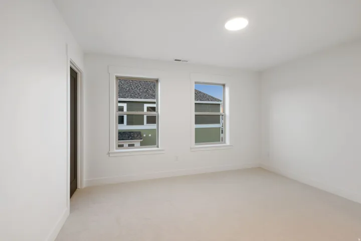 Recessed lighting complements two windows with white trim