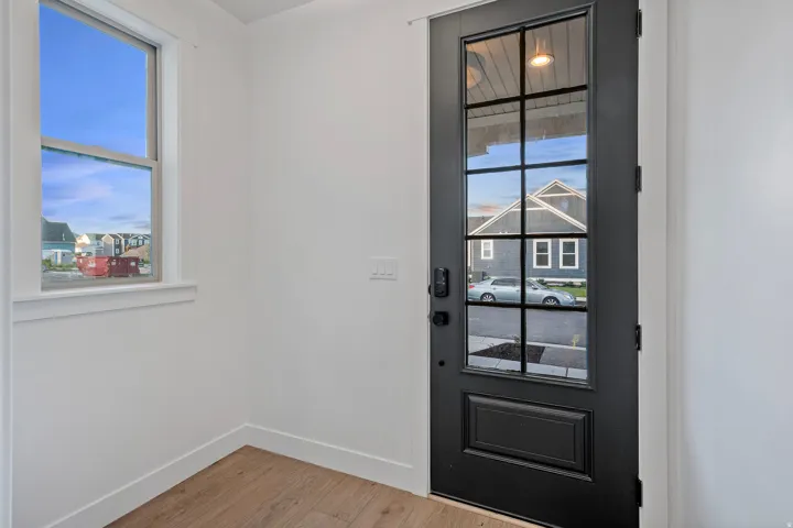 Black paneled entry door with grid-patterned glass